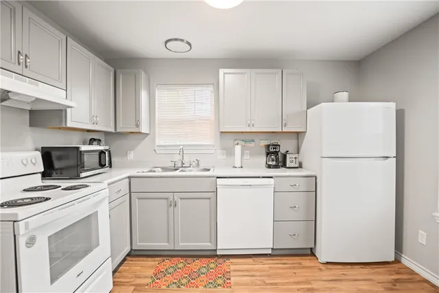 a kitchen with appliances a sink and a counter top space