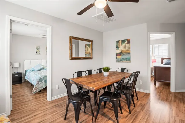 a view of a dining room with furniture and wooden floor