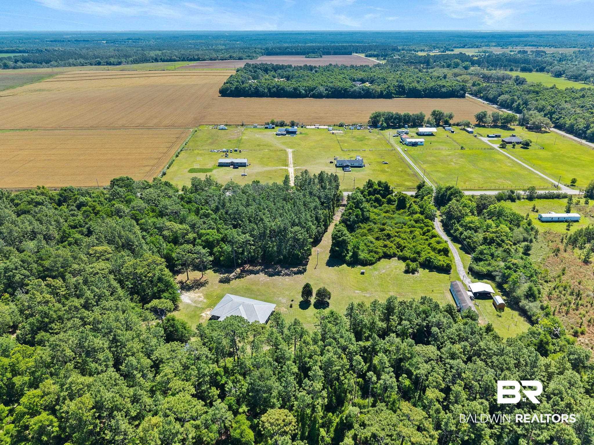 20219 Greek Cemetery Road Robertsdale, AL 36567 - Photo 38 of 41 Expansive land parcel featuring open fields, wooded areas, multiple structures, and established driveways
