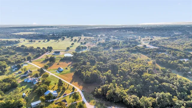 an aerial view of residential houses with outdoor space and swimming pool