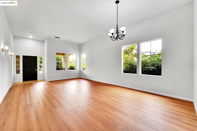a view of a livingroom with wooden floor and a ceiling fan