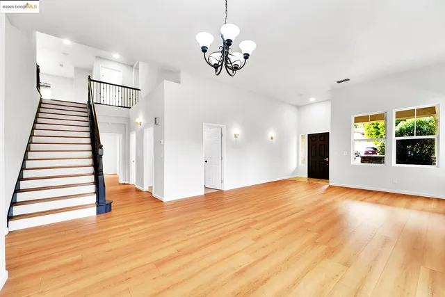a large white kitchen with cabinets
