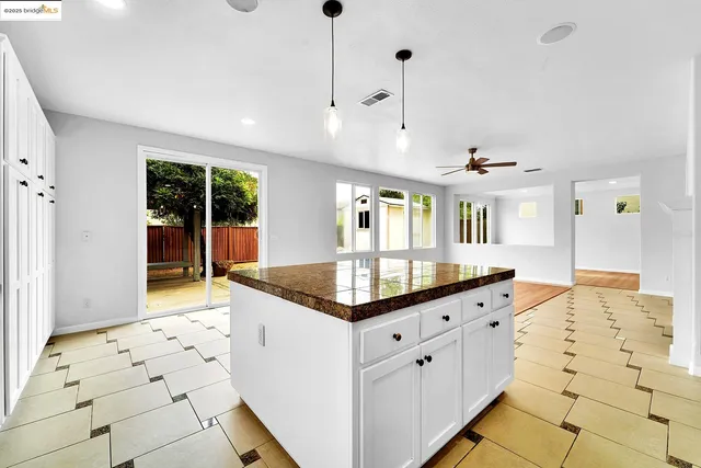 a kitchen with granite countertop a sink and a stove