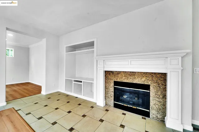 a bedroom with a fireplace and a bed