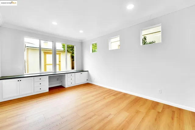 a view of a bedroom with wooden floor