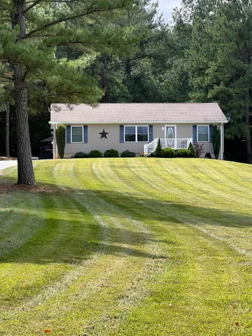a front view of a house with a big yard