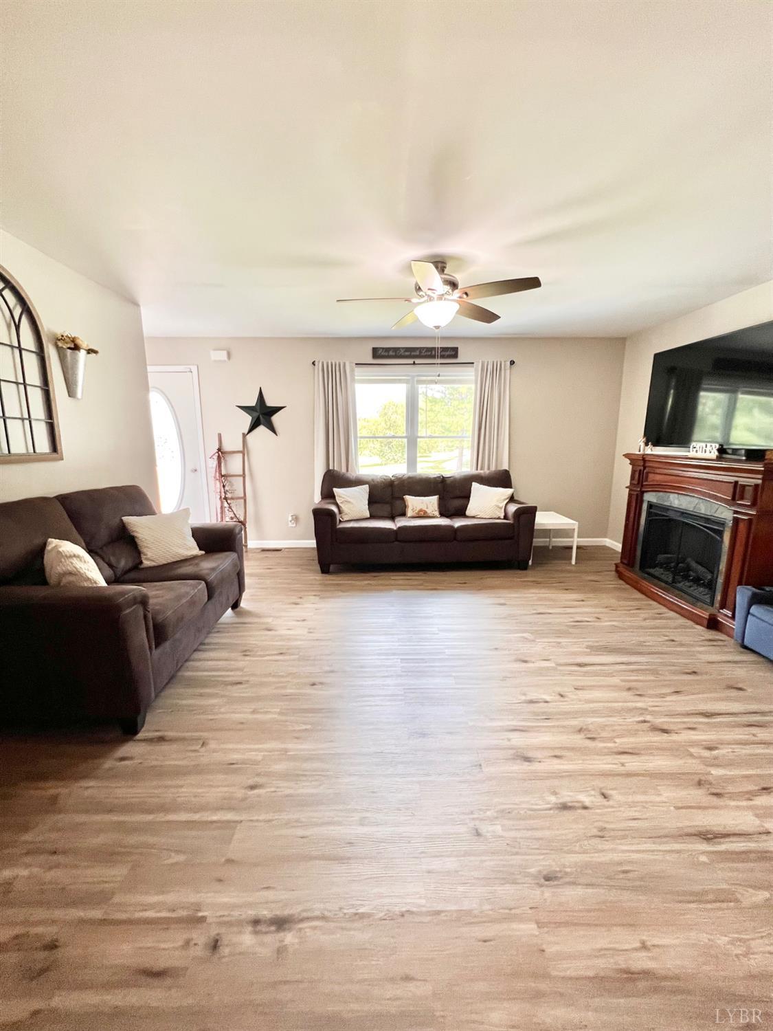 102 Fawn Court Amherst, VA 24521 - Photo 11 of 64 a living room with furniture and a flat screen tv