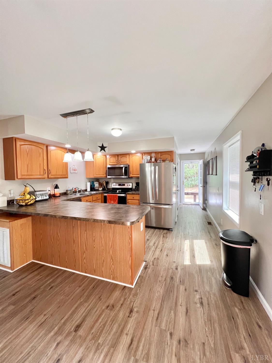 102 Fawn Court Amherst, VA 24521 - Photo 14 of 64 a view of a kitchen with kitchen island wooden floor and stainless steel appliances