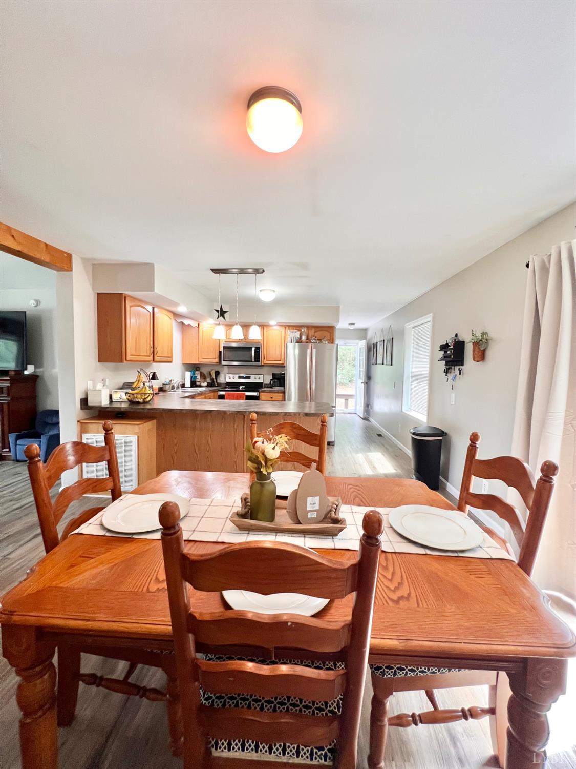 102 Fawn Court Amherst, VA 24521 - Photo 17 of 64 a dining room with a table and chairs