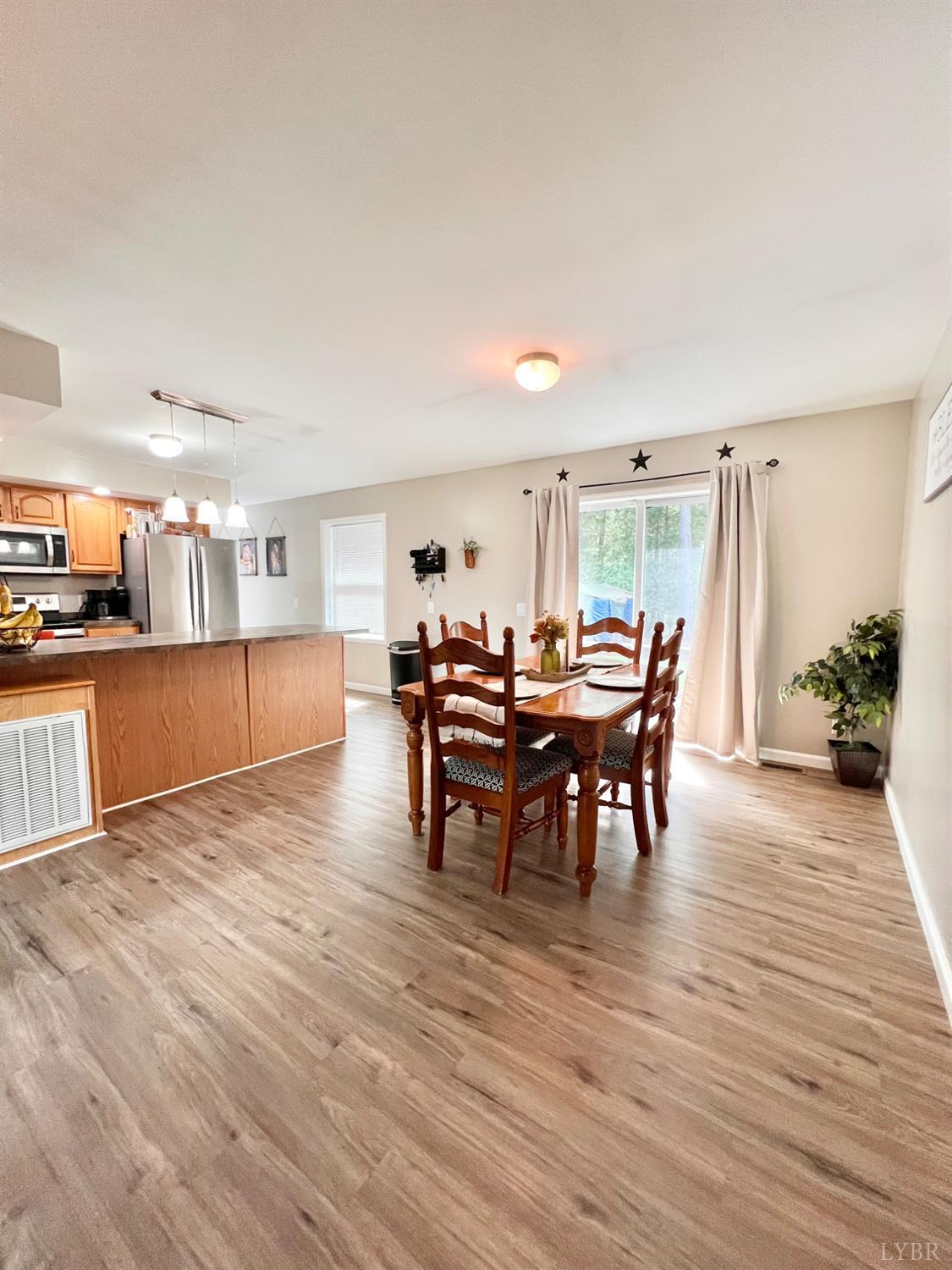 102 Fawn Court Amherst, VA 24521 - Photo 18 of 64 a view of a dining room with furniture and wooden floor
