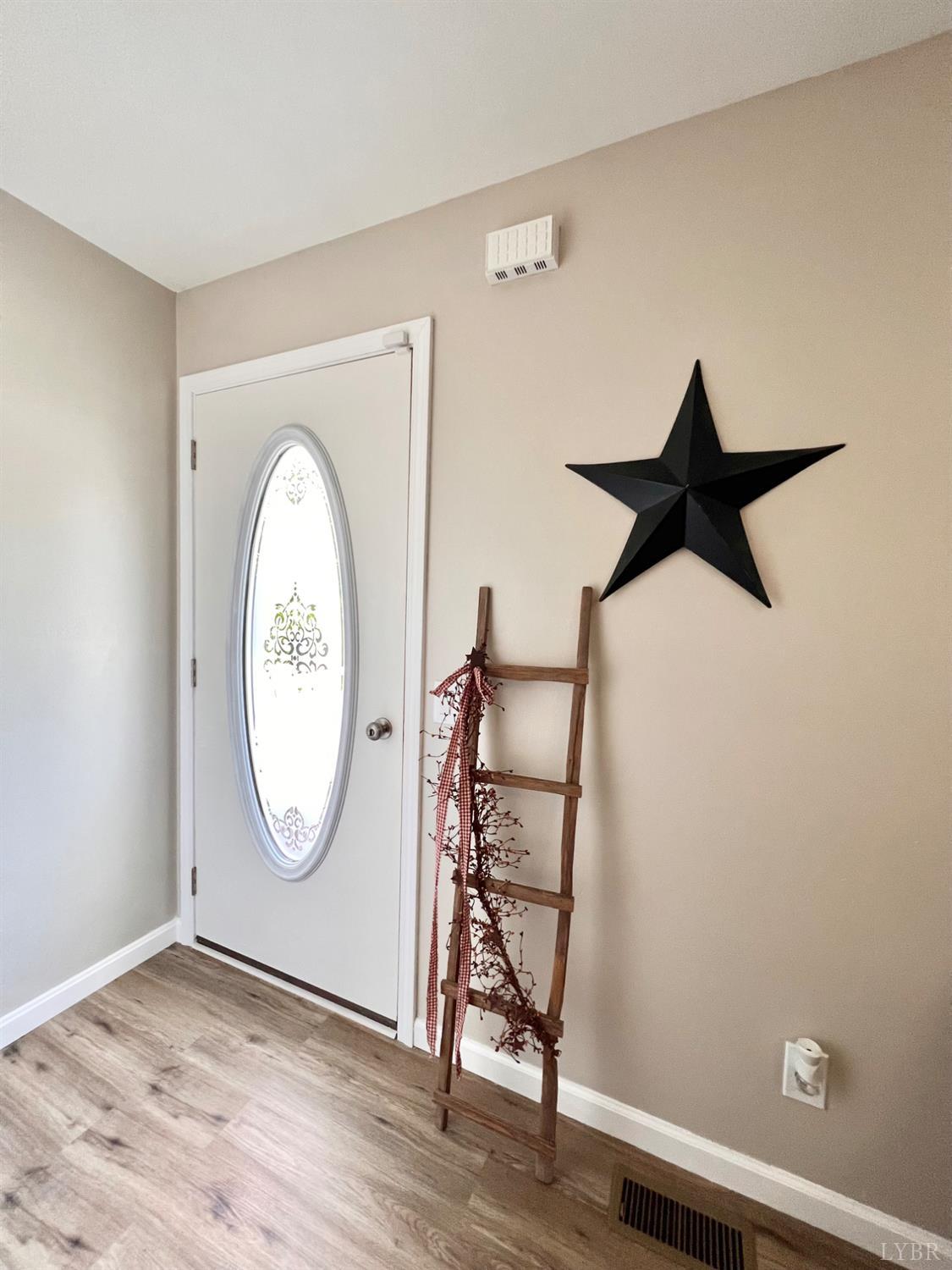102 Fawn Court Amherst, VA 24521 - Photo 20 of 64 an empty room with wooden floor mirror and fan