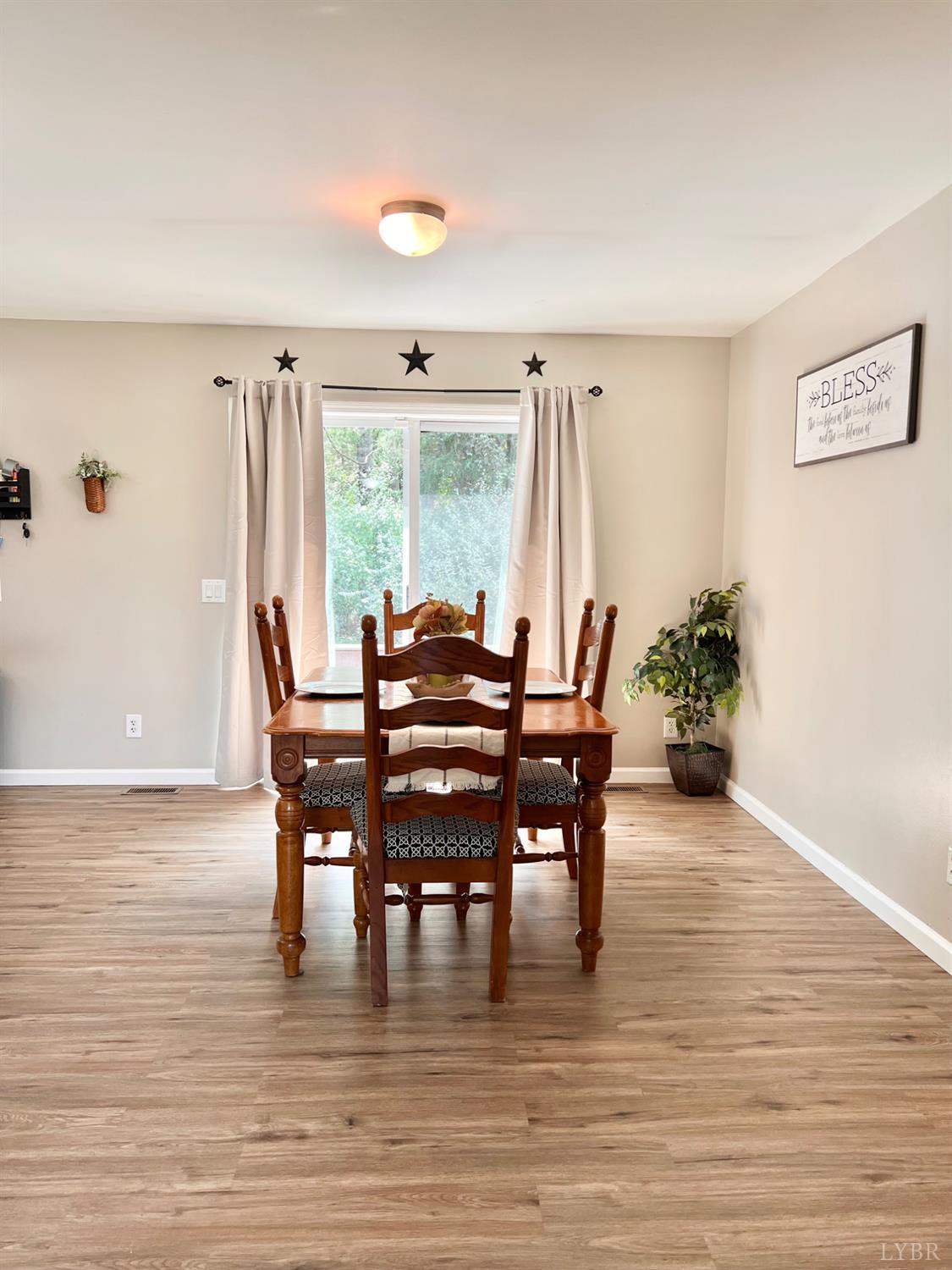 102 Fawn Court Amherst, VA 24521 - Photo 23 of 64 a view of a dining room with furniture and wooden floor