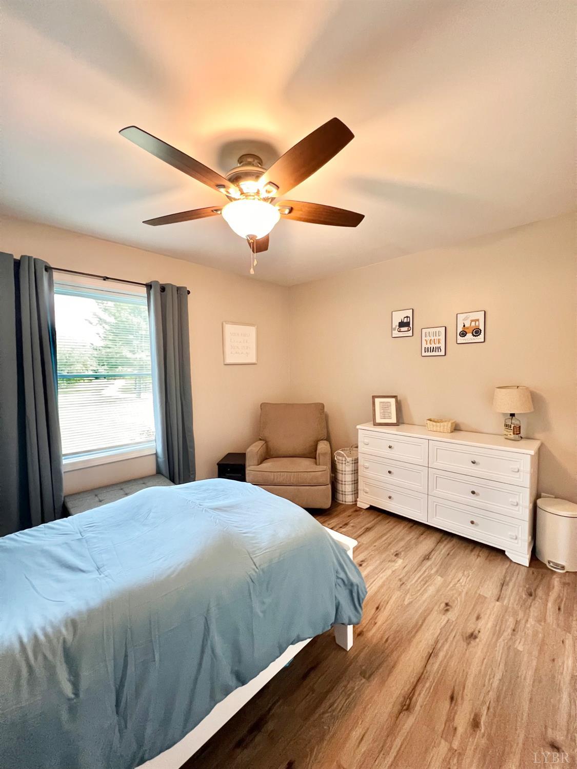 102 Fawn Court Amherst, VA 24521 - Photo 29 of 64 a bedroom with a bed and a chandelier