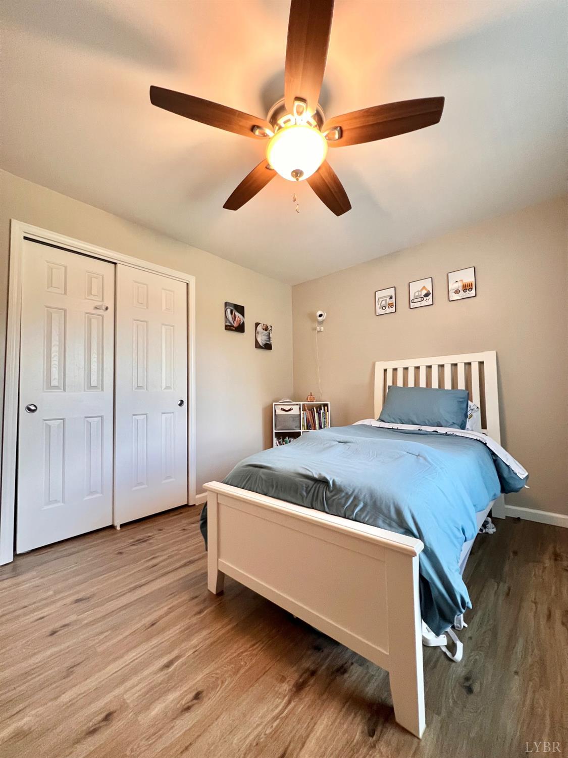 102 Fawn Court Amherst, VA 24521 - Photo 30 of 64 a spacious bedroom with a bed and a chandelier