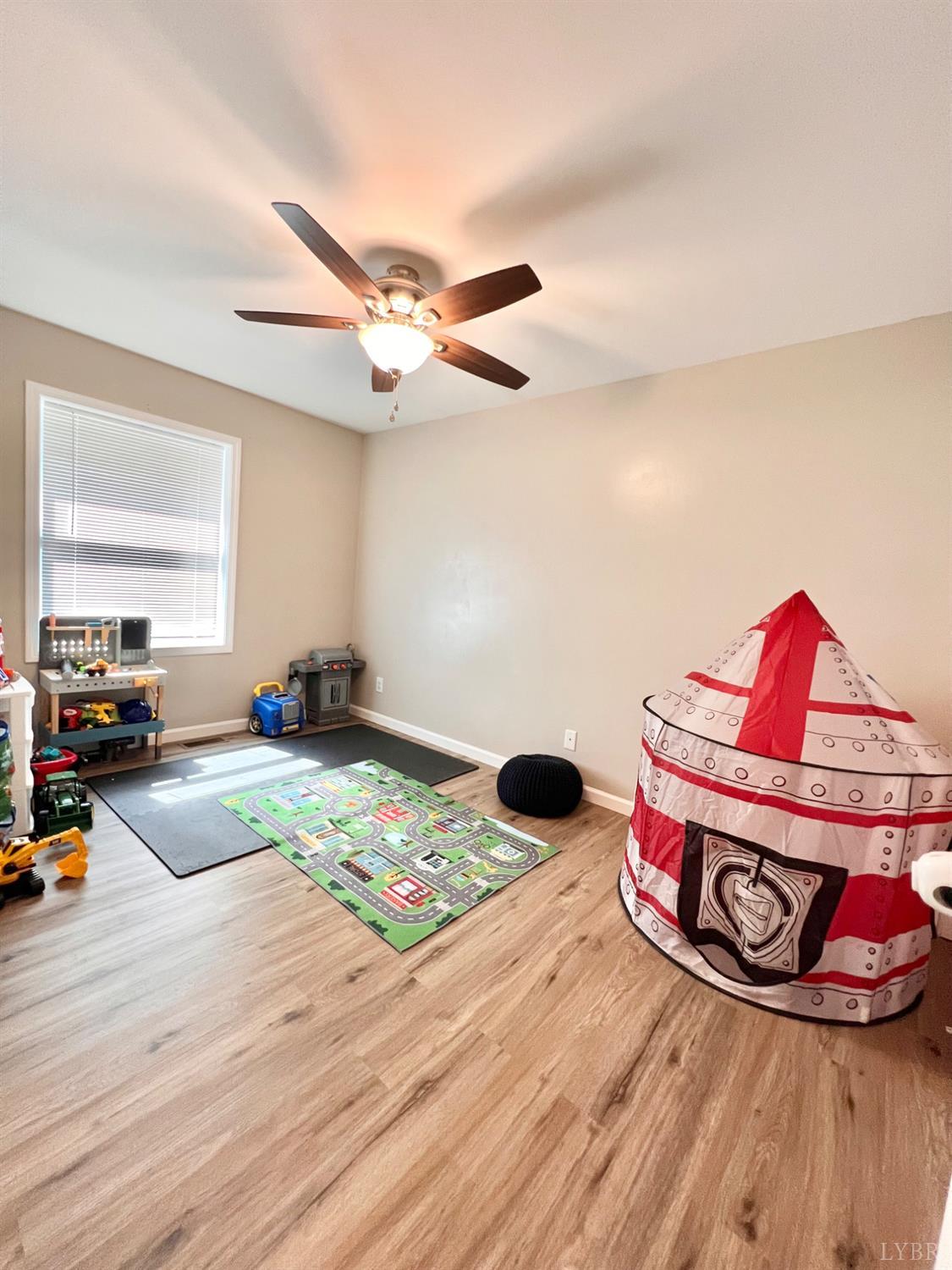 102 Fawn Court Amherst, VA 24521 - Photo 35 of 64 a view of a room with wooden floor and ceiling fan