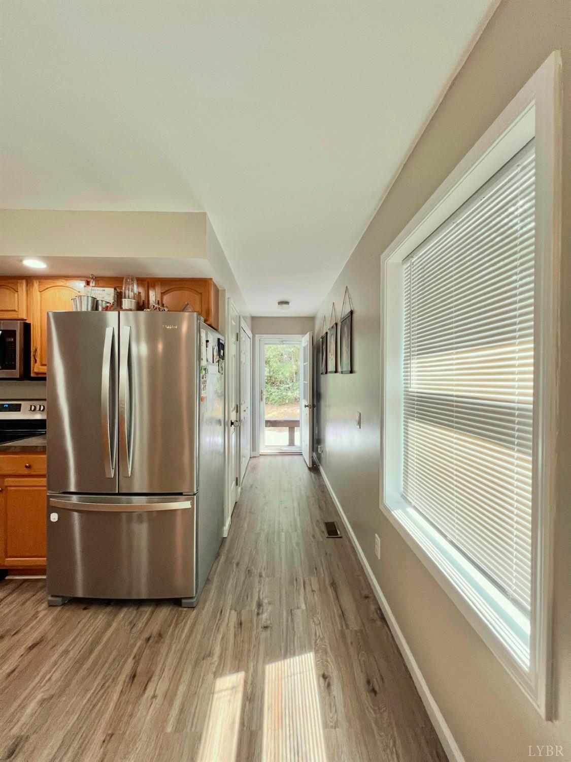 102 Fawn Court Amherst, VA 24521 - Photo 37 of 64 a view of a kitchen with wooden floor electronic appliances and windows