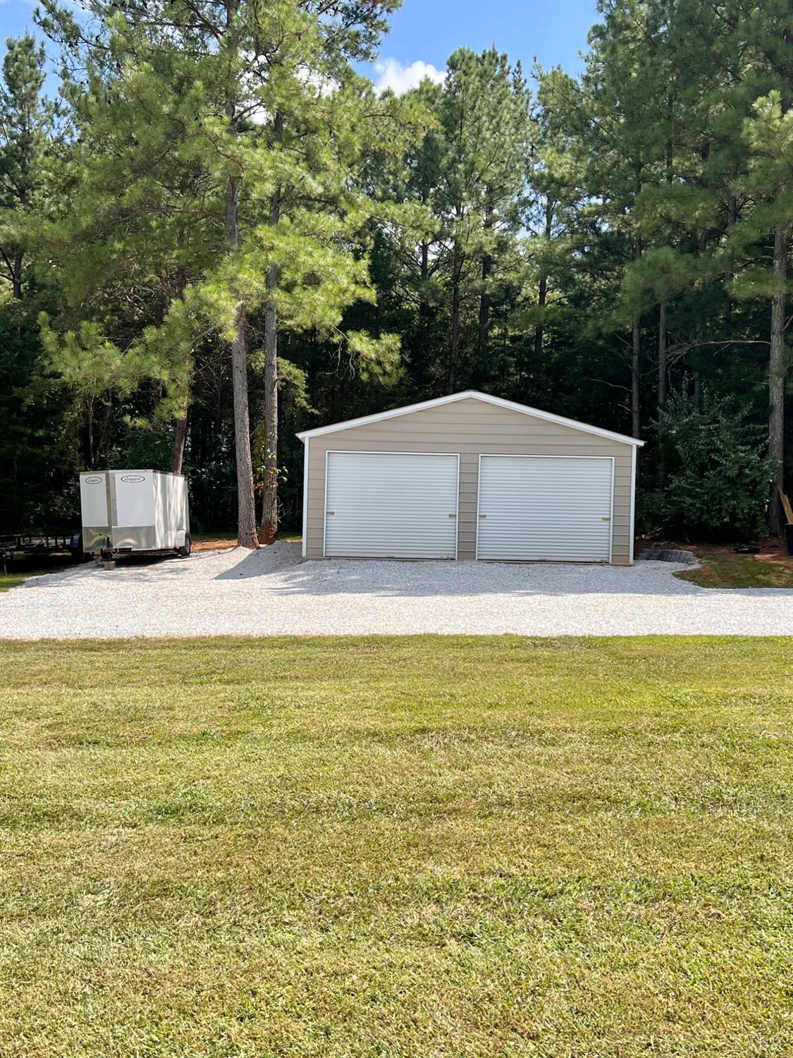 102 Fawn Court Amherst, VA 24521 - Photo 51 of 64 a view of a swimming pool with an outdoor seating and a forest