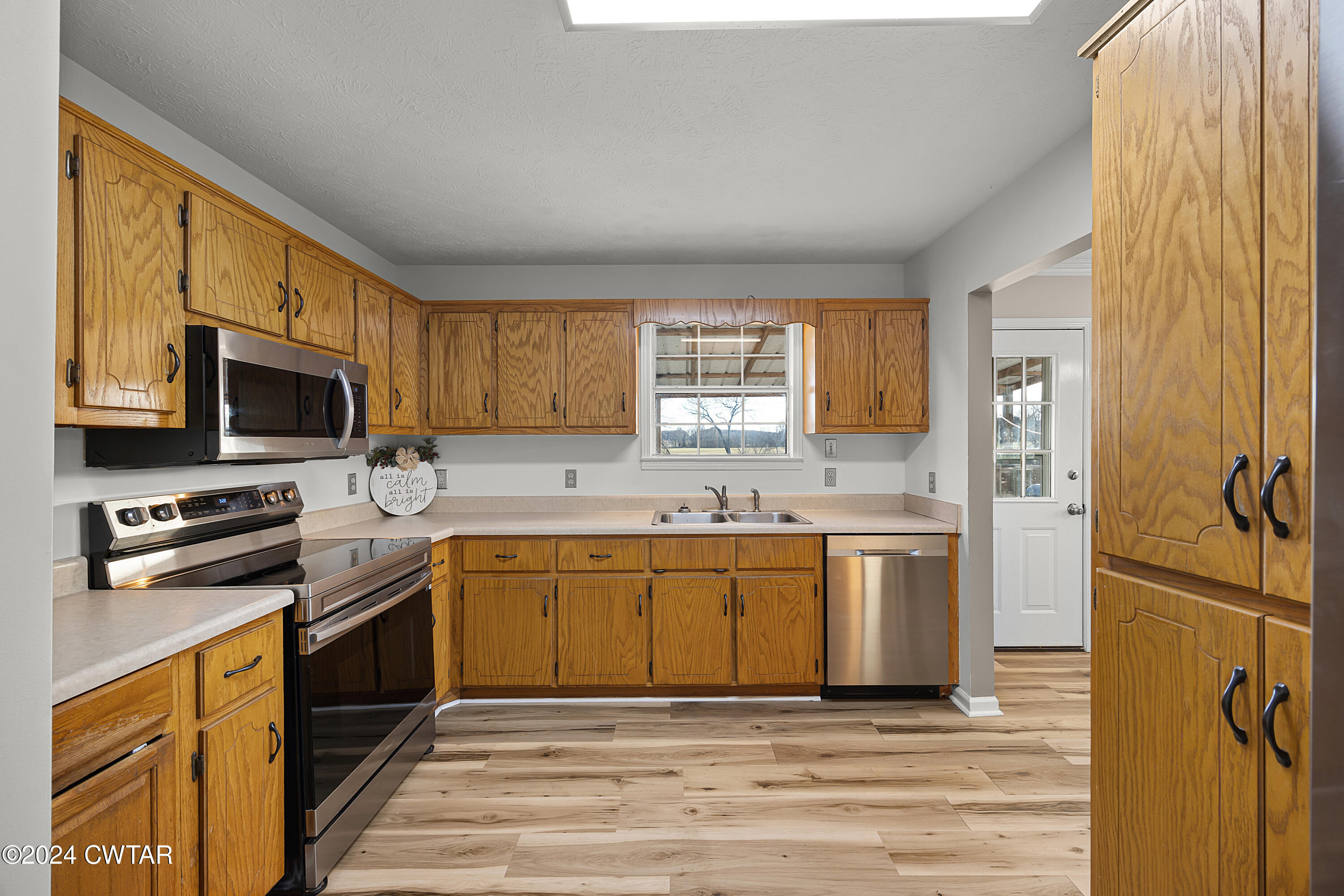 650 Gobelet Road Medon, TN 38356 - Photo 7 of 21 a kitchen with stainless steel appliances granite countertop a stove a sink dishwasher a refrigerator and a microwave oven