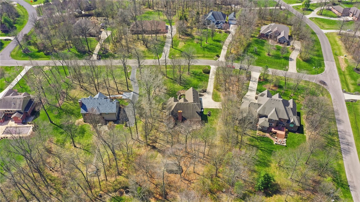 472 Timber Walk Court Springboro, OH 45066 - Photo 81 of 86 An aerial view captures a serene residential area with large homes nestled among lush greenery and winding roads.