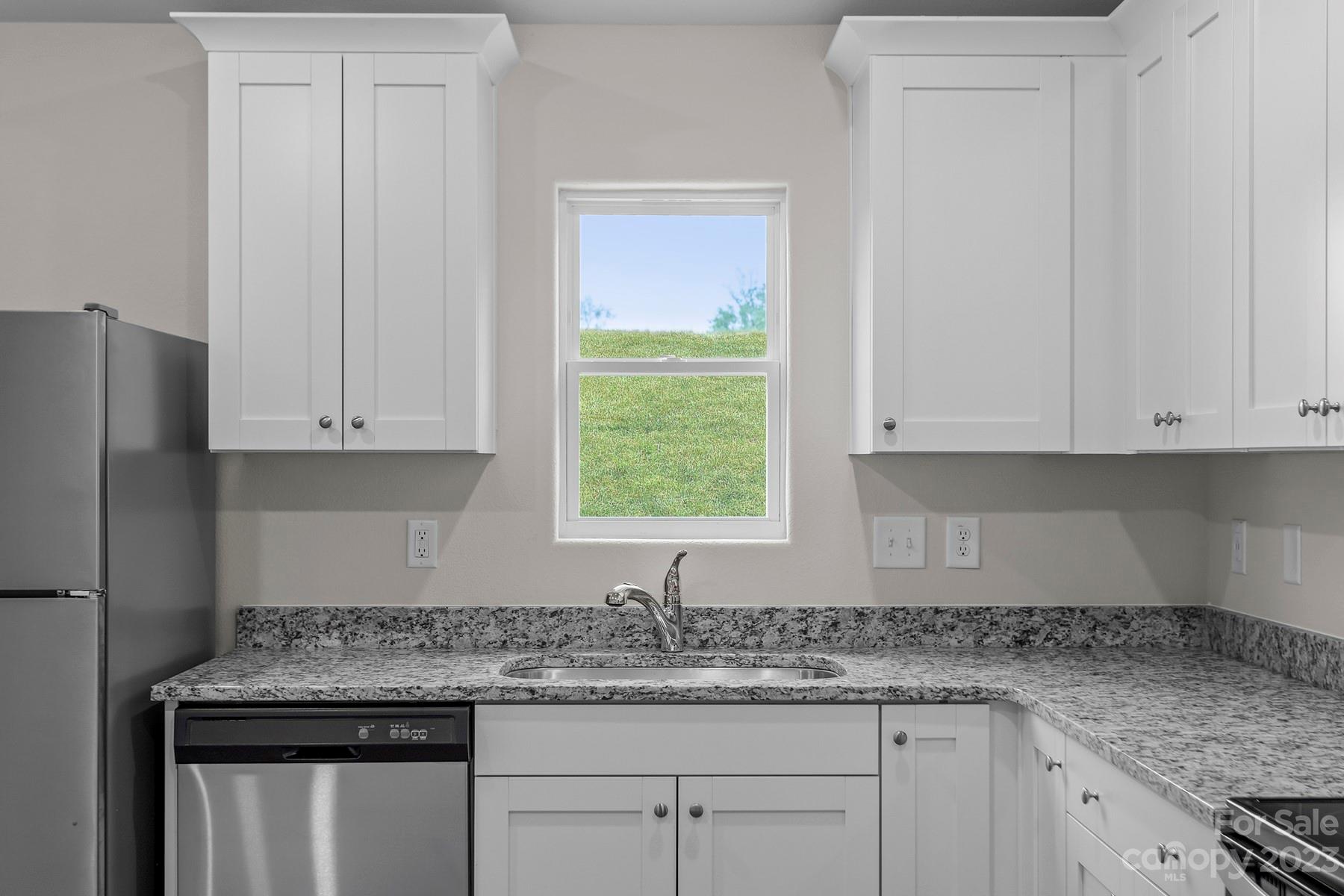 1716 Nia Road Charlotte, NC 28215 - Photo 4 of 10 a kitchen with granite countertop white cabinets and a window