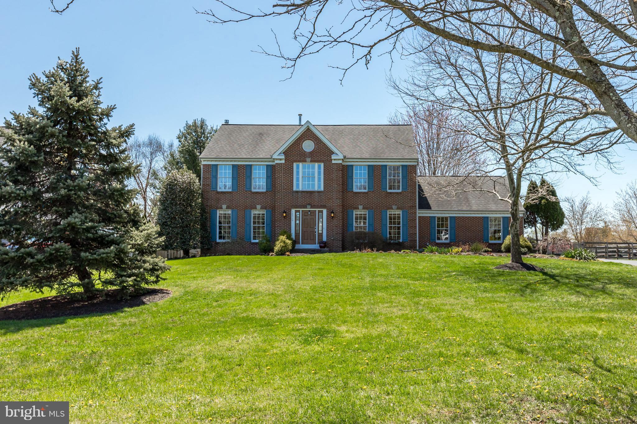 16910 Hoskinson Road Poolesville, MD 20837 - Photo 1 of 30 a front view of a house with a garden