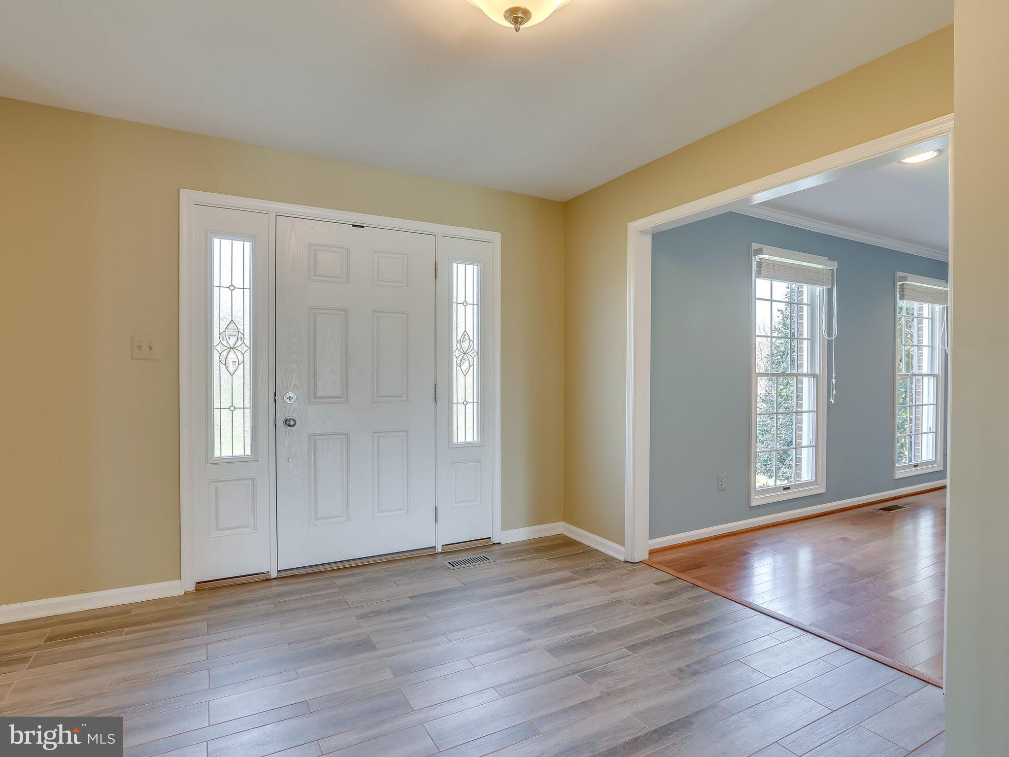 16910 Hoskinson Road Poolesville, MD 20837 - Photo 13 of 30 a view of an empty room with wooden floor and a window