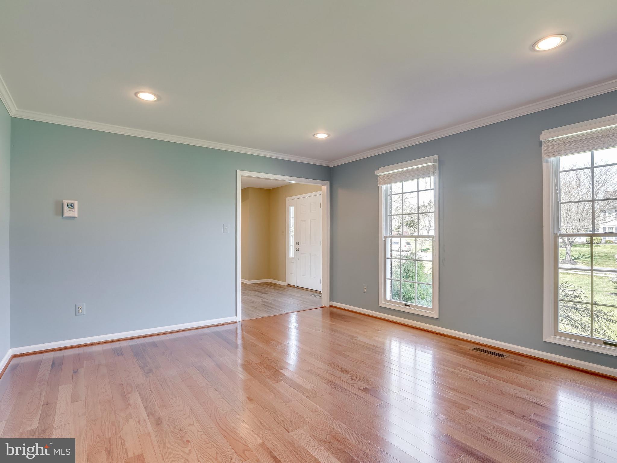 16910 Hoskinson Road Poolesville, MD 20837 - Photo 16 of 30 a view of an empty room with wooden floor and a window