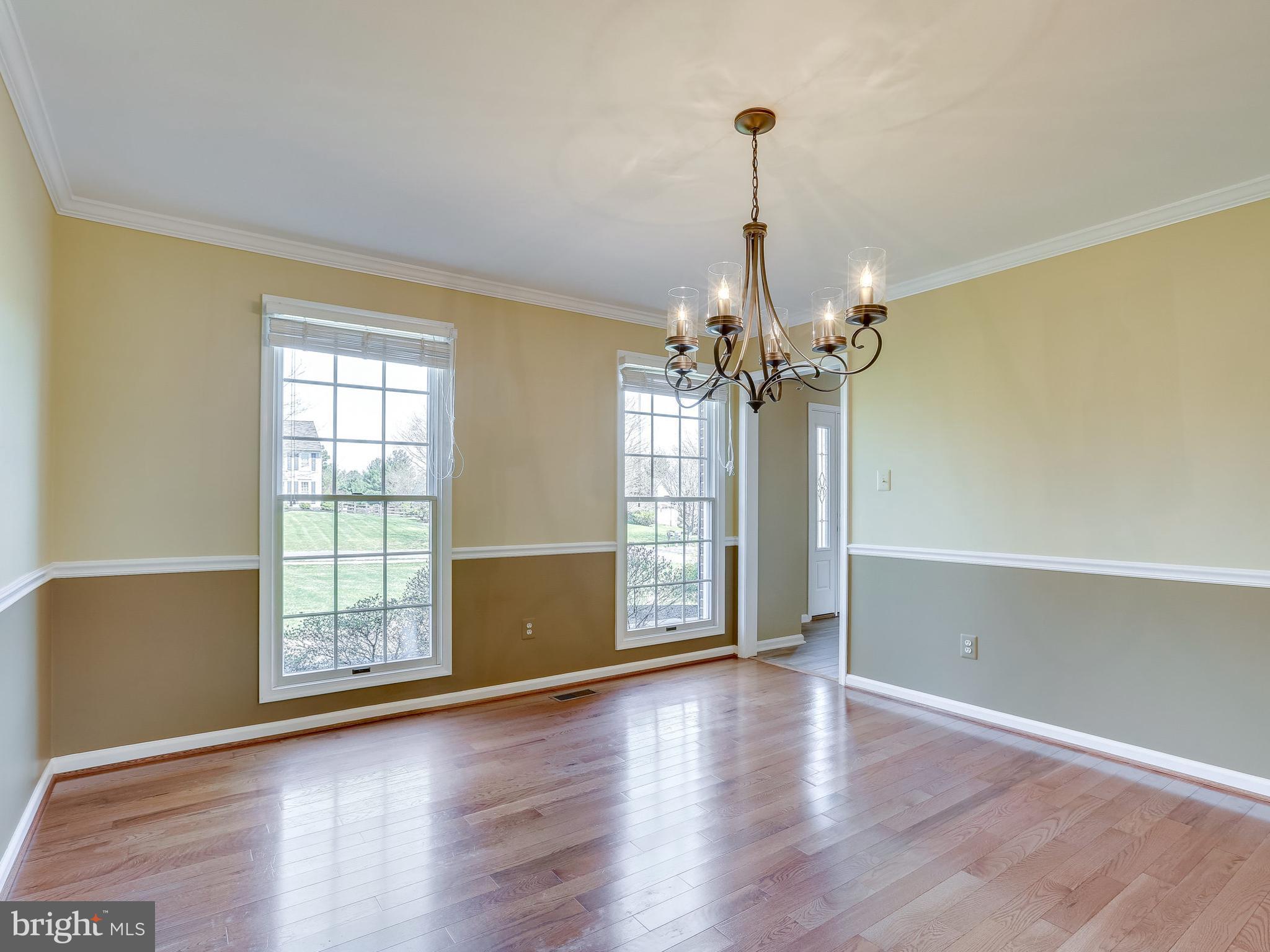 16910 Hoskinson Road Poolesville, MD 20837 - Photo 17 of 30 a view of a room with wooden floor chandelier and windows