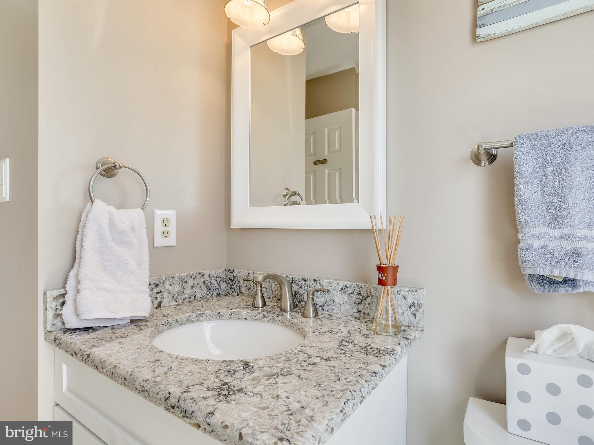 16910 Hoskinson Road Poolesville, MD 20837 - Photo 18 of 30 a bathroom with a granite countertop sink and a mirror