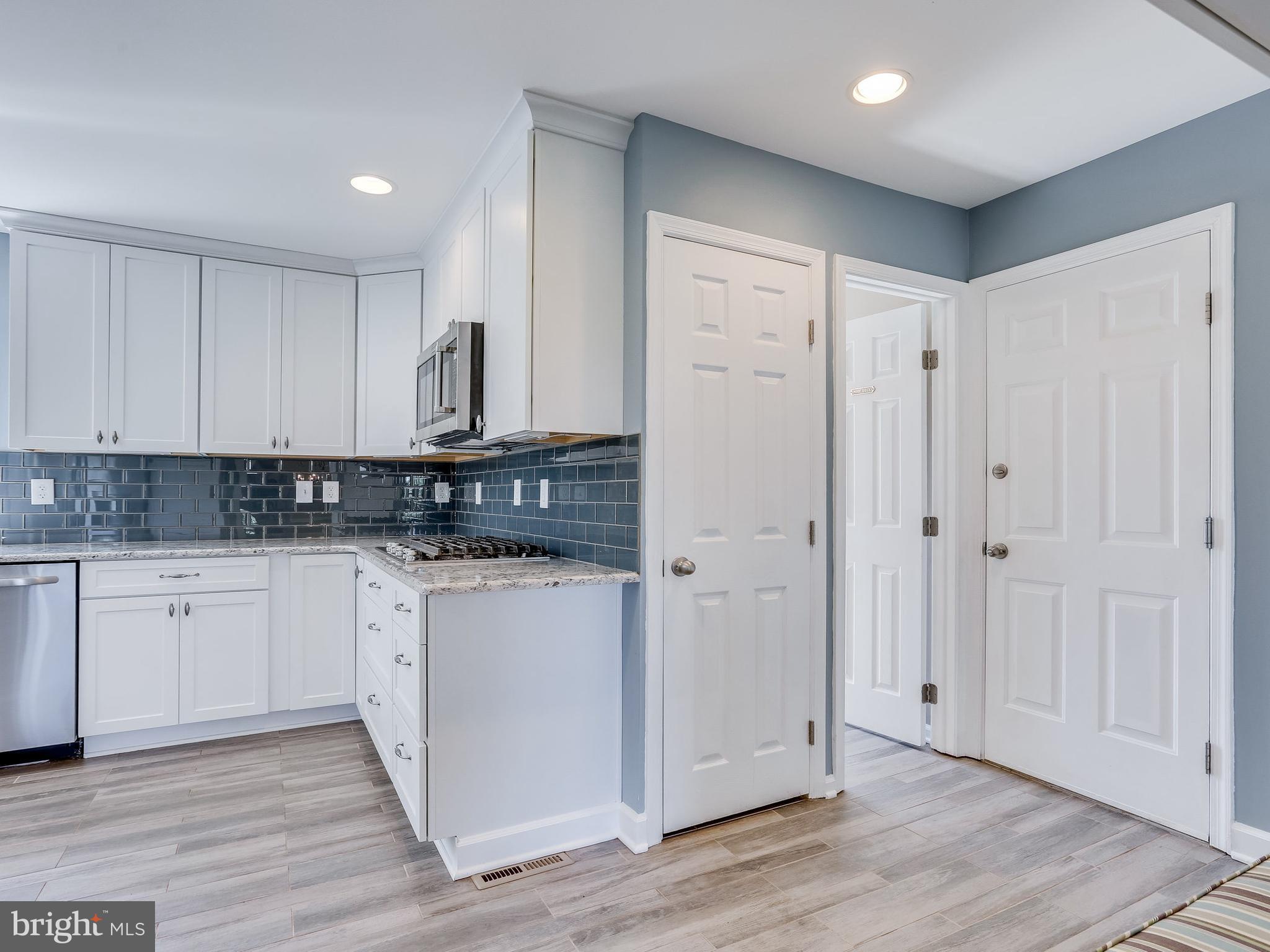 16910 Hoskinson Road Poolesville, MD 20837 - Photo 3 of 30 a view of a kitchen with white cabinets