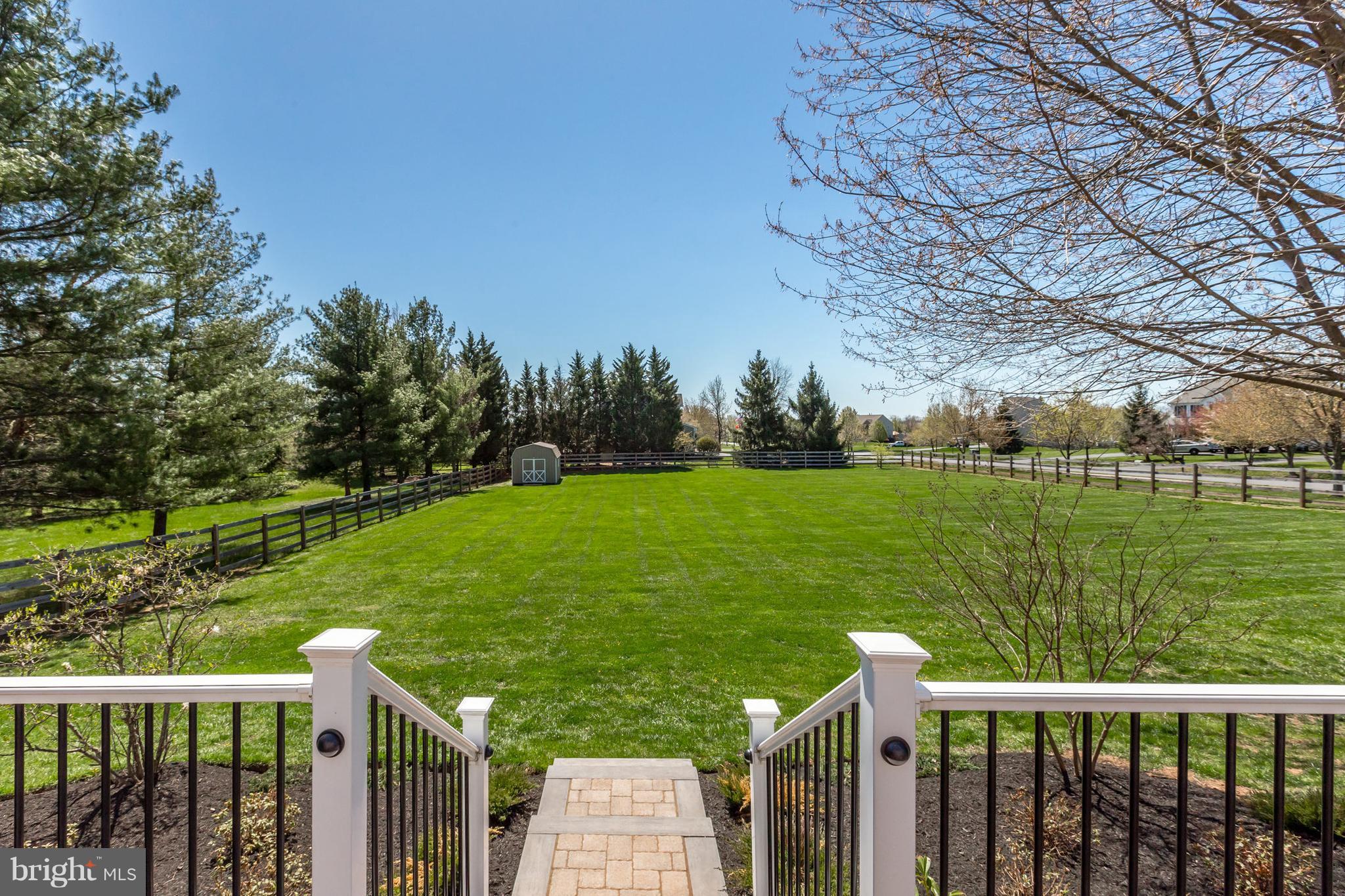 16910 Hoskinson Road Poolesville, MD 20837 - Photo 27 of 30 a view of a deck and yard with large trees