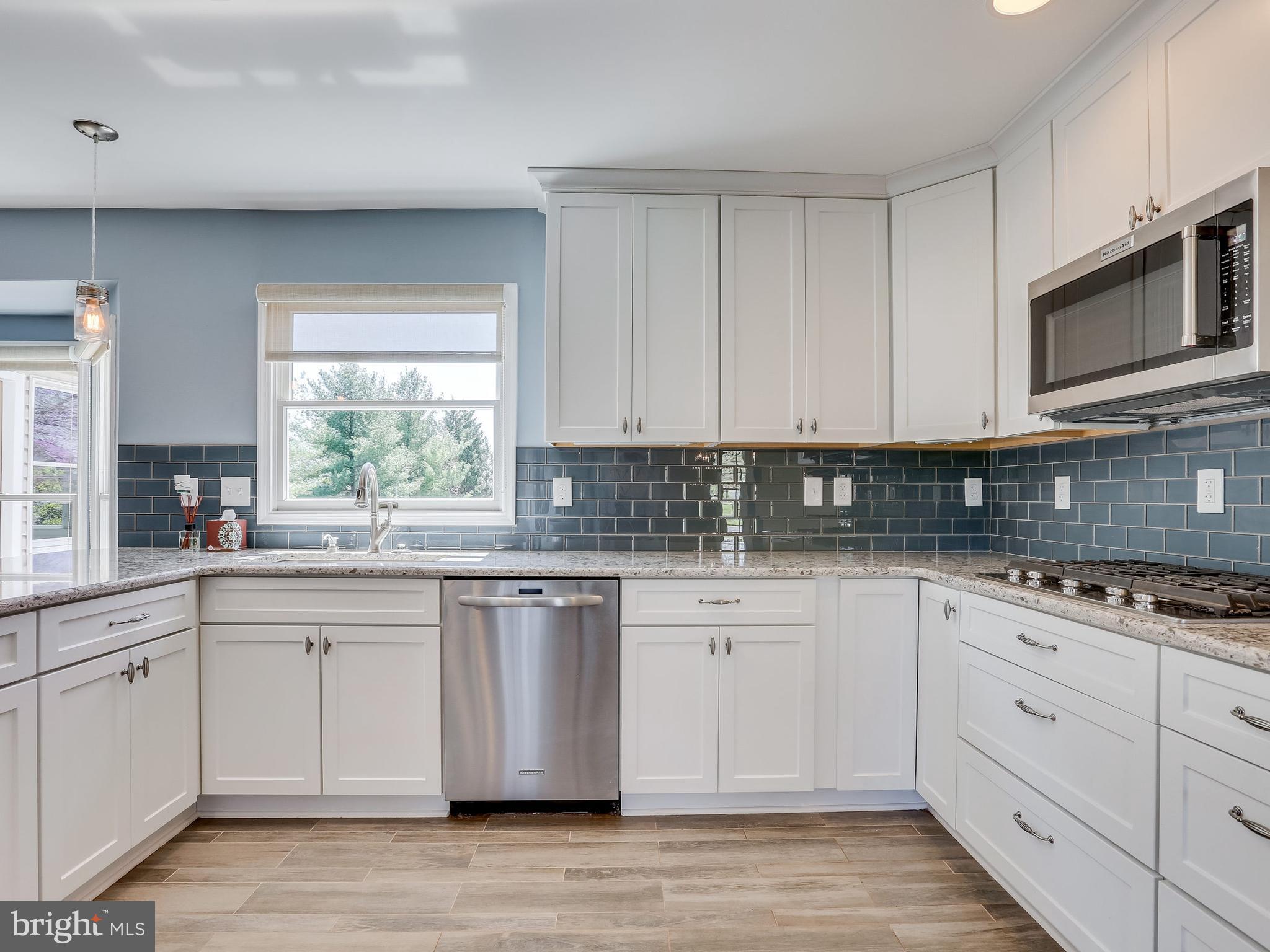 16910 Hoskinson Road Poolesville, MD 20837 - Photo 4 of 30 a kitchen with granite countertop white cabinets white stainless steel appliances a sink and a window