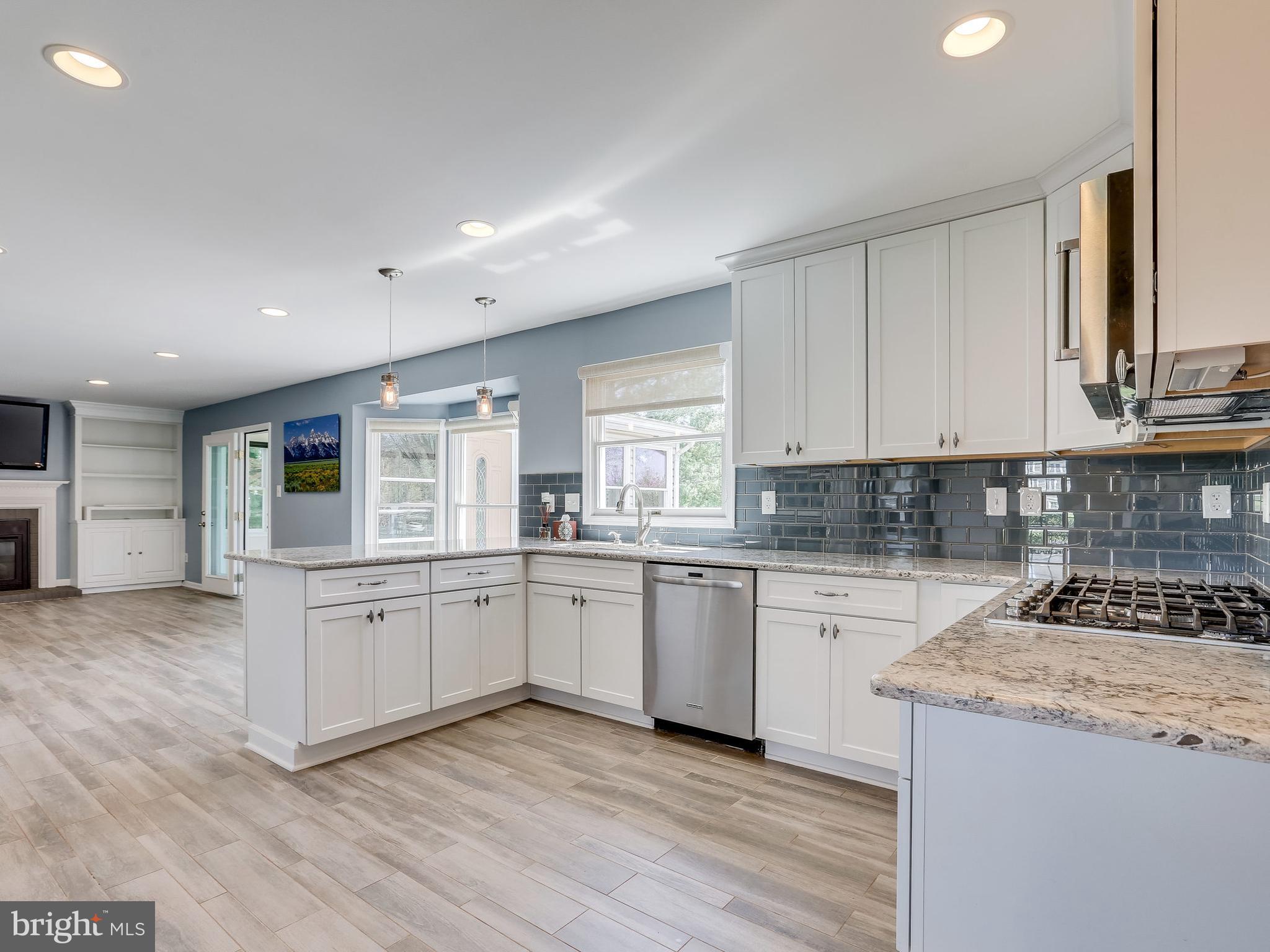 16910 Hoskinson Road Poolesville, MD 20837 - Photo 5 of 30 a kitchen with granite countertop white cabinets and white appliances
