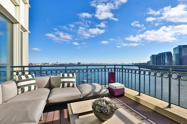20 Rowes Wharf, Unit 610 Boston, MA 02110 - Photo 2 of 20 a roof deck with couches and wooden floor