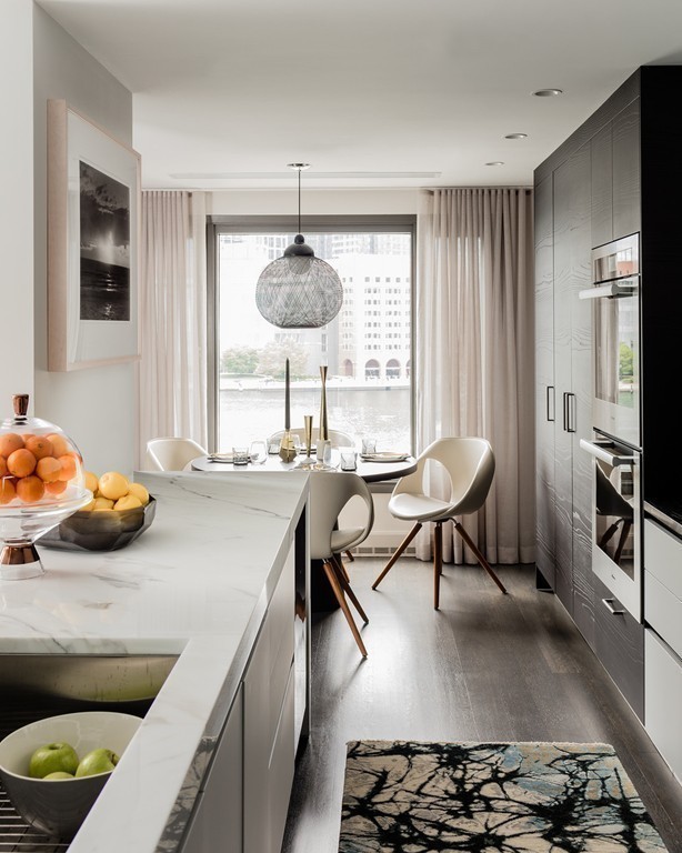 20 Rowes Wharf, Unit 610 Boston, MA 02110 - Photo 6 of 20 a kitchen with a table and chairs