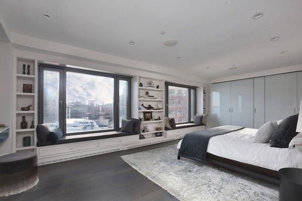 a bedroom with a large bed and a large window