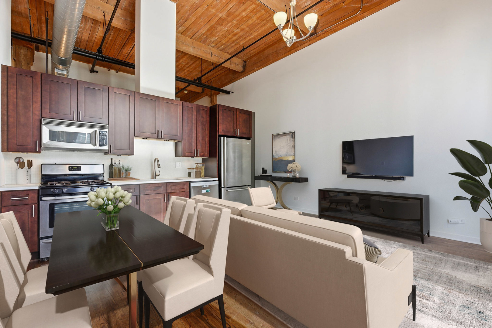 215 North Aberdeen Street, Unit 607B Chicago, IL 60607 - Photo 4 of 12 a kitchen with stainless steel appliances a stove refrigerator sink and microwave