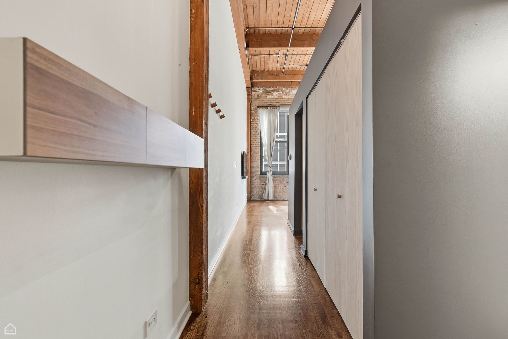 215 North Aberdeen Street, Unit 607B Chicago, IL 60607 - Photo 9 of 12 a view of a hallway with wooden floor and staircase