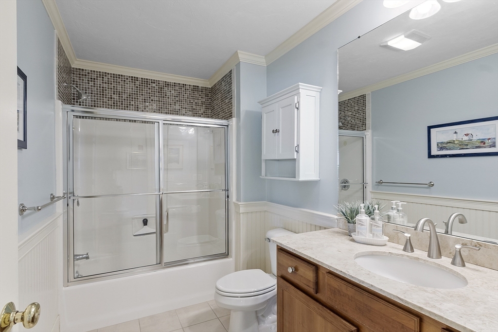 22 Hummock Way, Unit 22 Hudson, MA 01749 - Photo 17 of 23 a bathroom with a granite countertop sink toilet and shower