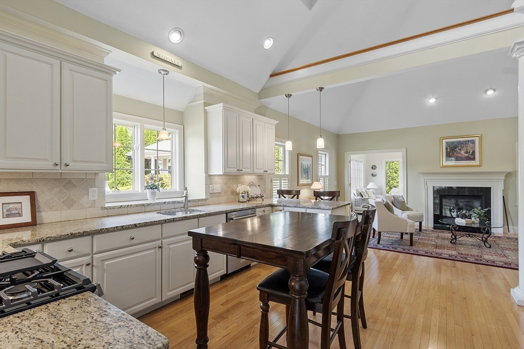 22 Hummock Way, Unit 22 Hudson, MA 01749 - Photo 7 of 23 a kitchen with a dining table chairs and fireplace