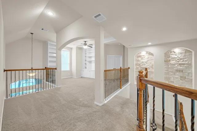 a view of staircase with lots of white furniture