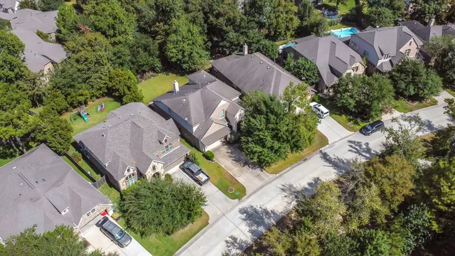 an aerial view of a house with a yard