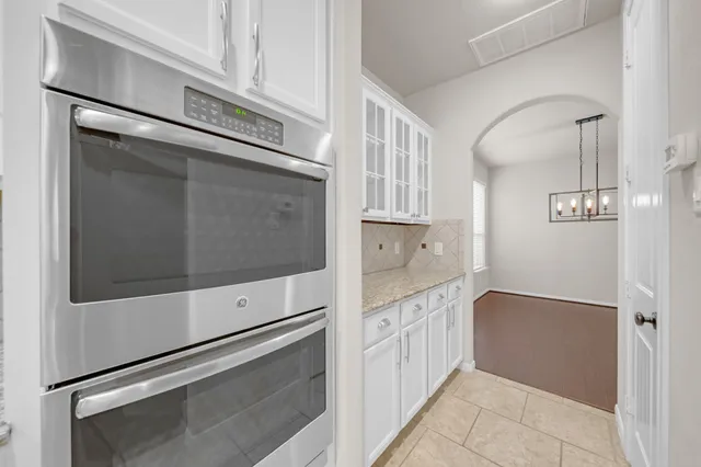 a kitchen with white cabinets and white appliances