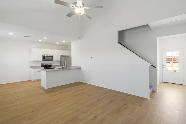 a view of kitchen with sink and microwave