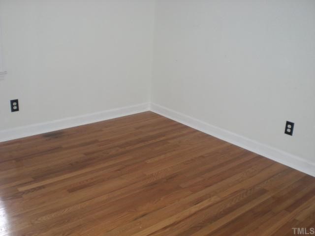 3113 Sherry Drive Raleigh, NC 27604 - Photo 6 of 12 a view of an empty room with wooden floor
