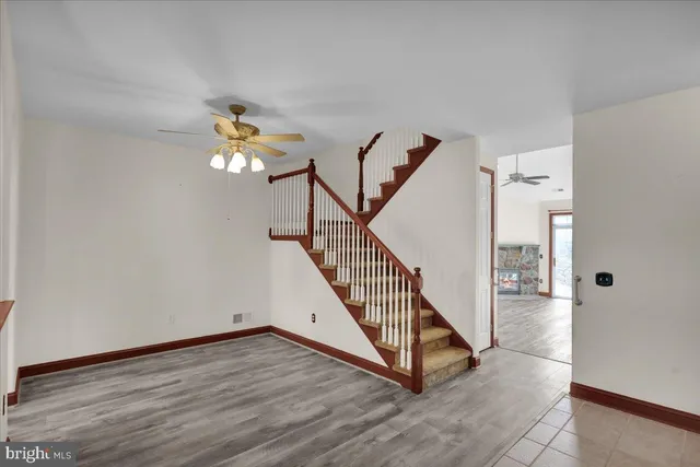 a view of a livingroom with wooden floor and stairs