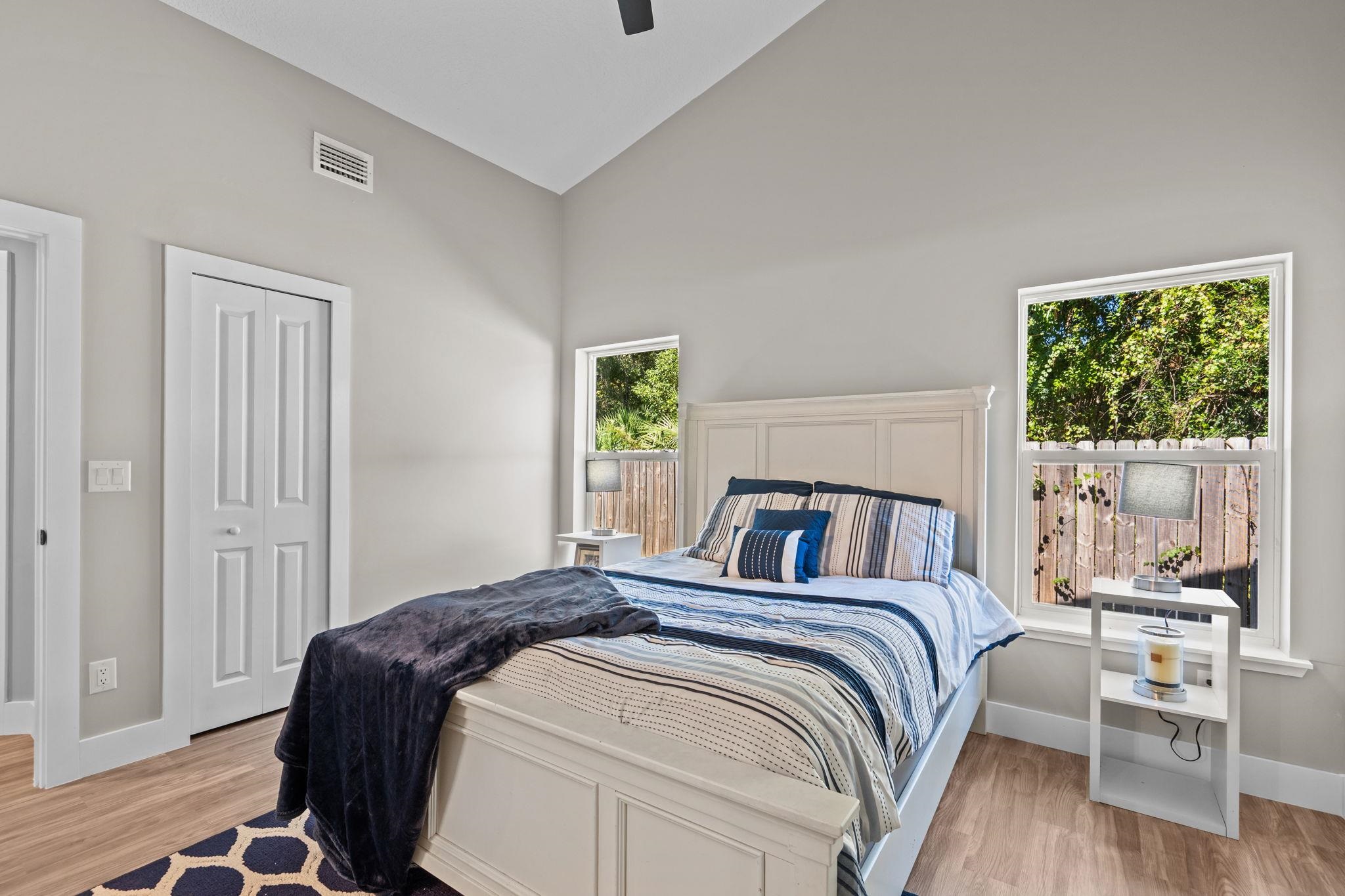 812 West 9th Street St. Augustine, FL 32084 - Photo 13 of 31 Bedroom with lofted ceiling, light wood-style floors, a closet, and a ceiling fan