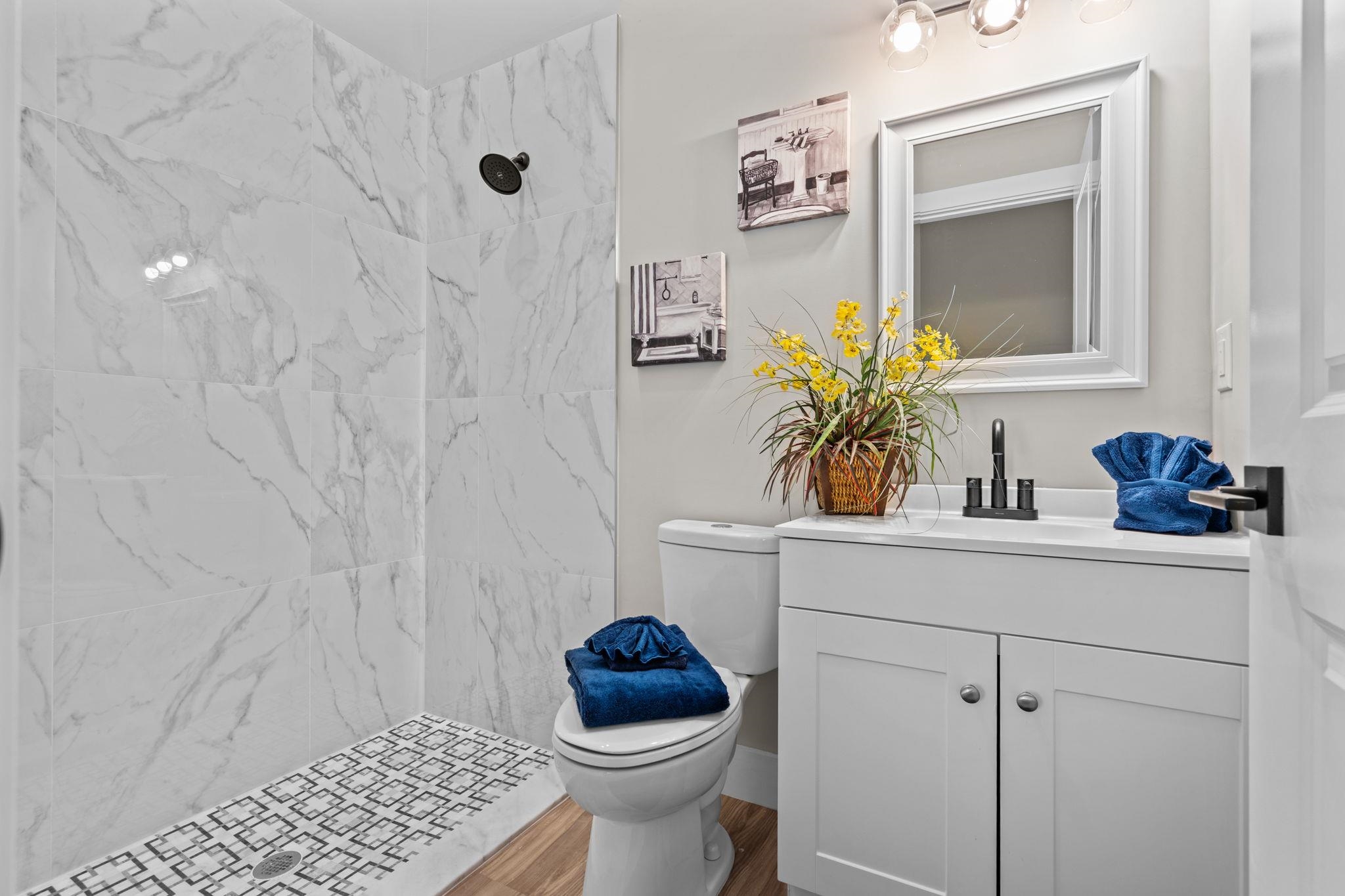 812 West 9th Street St. Augustine, FL 32084 - Photo 15 of 31 Bathroom featuring vanity and a marble finish shower