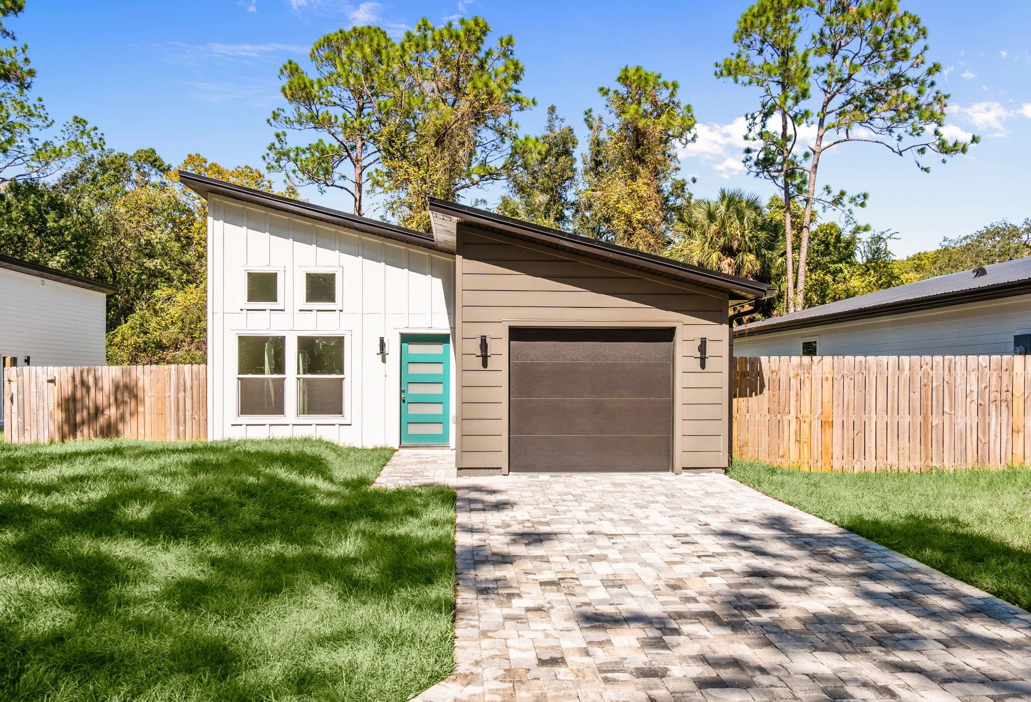 812 West 9th Street St. Augustine, FL 32084 - Photo 2 of 31 View of front of property featuring board and batten siding, decorative driveway, and a garage