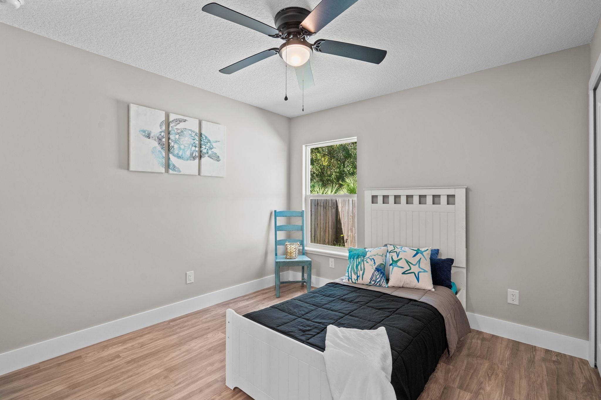 812 West 9th Street St. Augustine, FL 32084 - Photo 19 of 31 Bedroom featuring wood finished floors, a textured ceiling, ceiling fan, and a closet